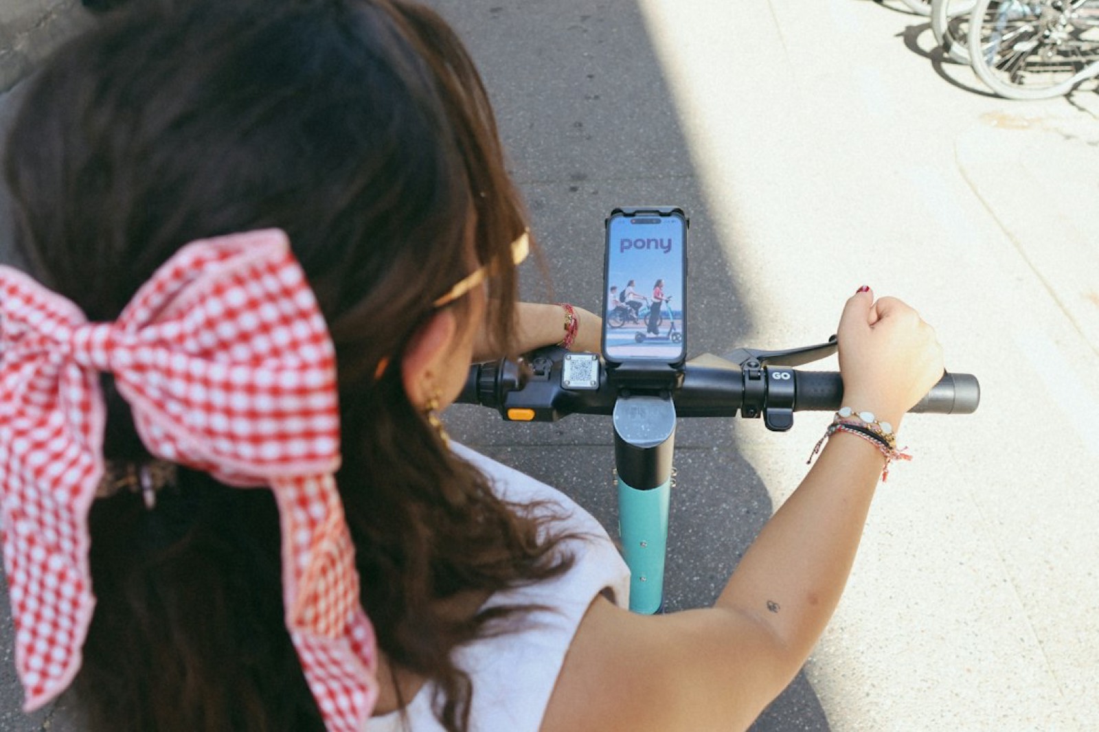 Conducteur de scooter consultant son téléphone fixé sur le guidon dans la circulation
